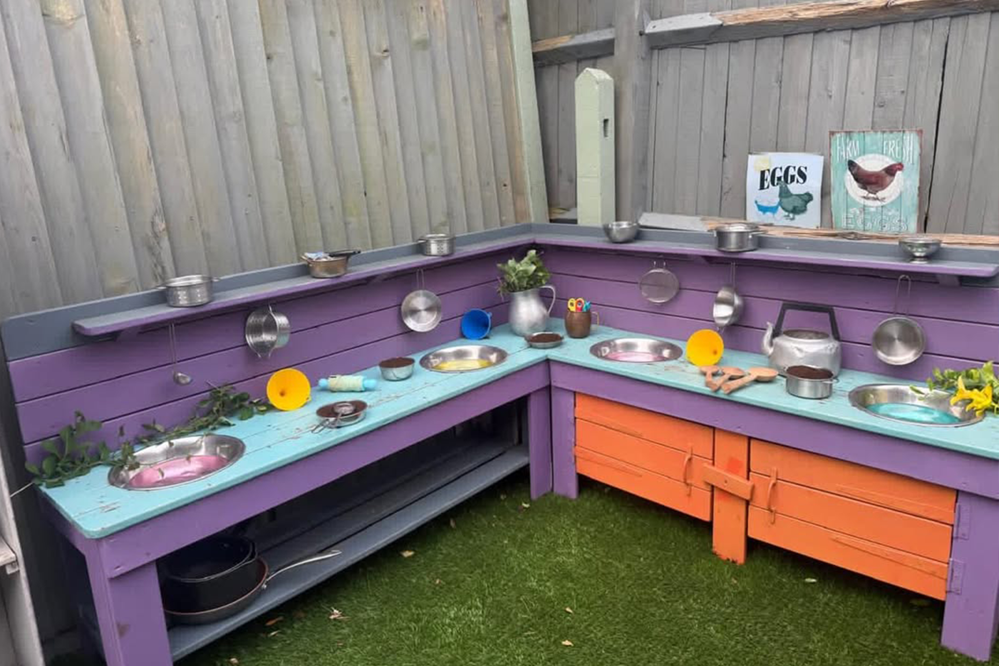 The outdoor mud kitchen at Casa Montessori, set up with pans and utensils